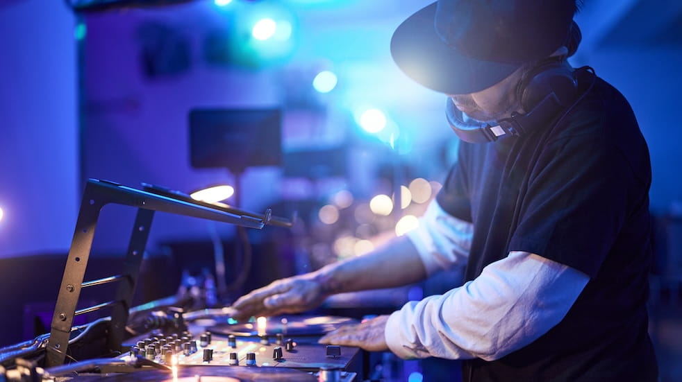 A man mixing at a DJ deck